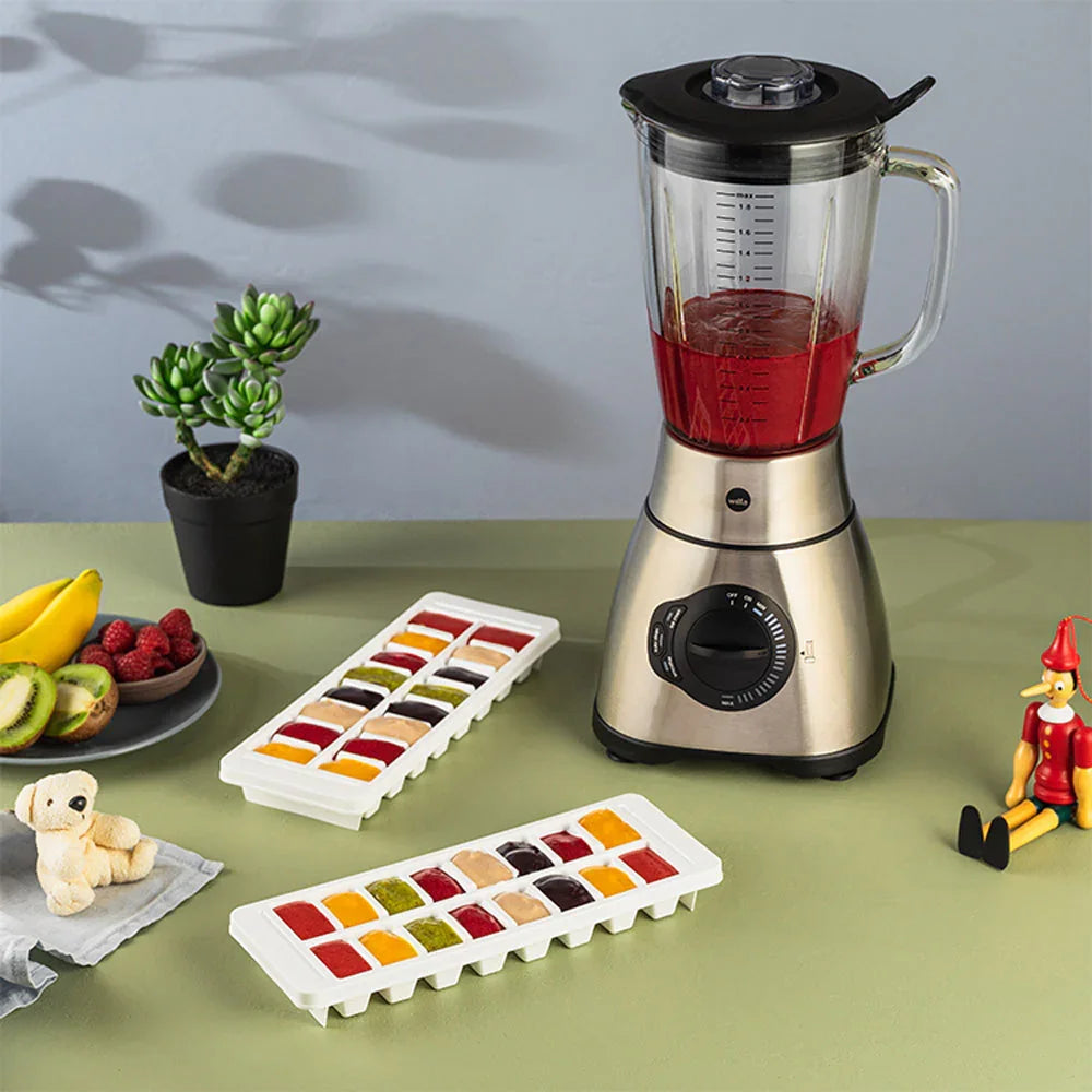 Stand mixer with glass jug and black lid; speed control dial on base